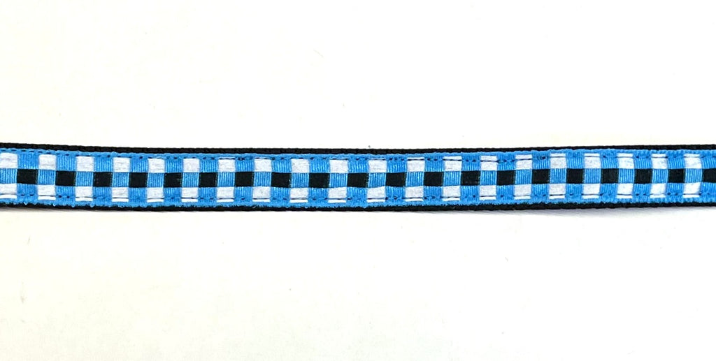 Black webbing dog collar with blue, black, and white plaid ribbon