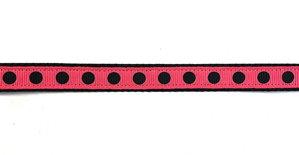 Black webbing dog collar with bright pink and black dot ribbon