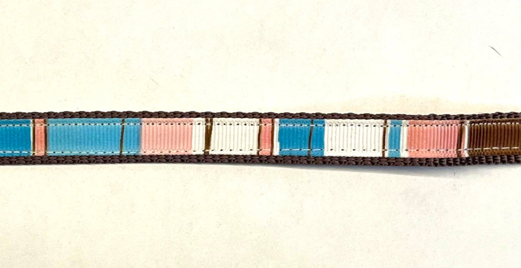 Brown, light pink, pink, blue, and white vertical stripe ribbon on brown webbing dog collar