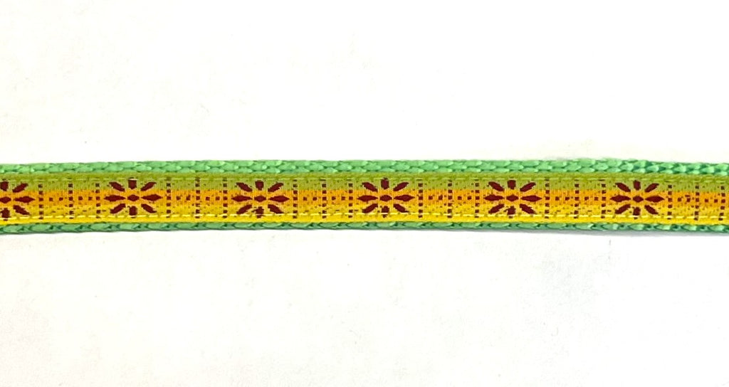 Green, orange, and yellow stripe ribbon with burgundy flower pattern dog collar on green webbing