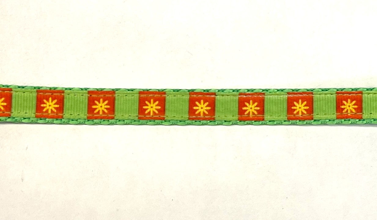 Green and orange ribbon with yellow daisy flowers dog collar on green webbing