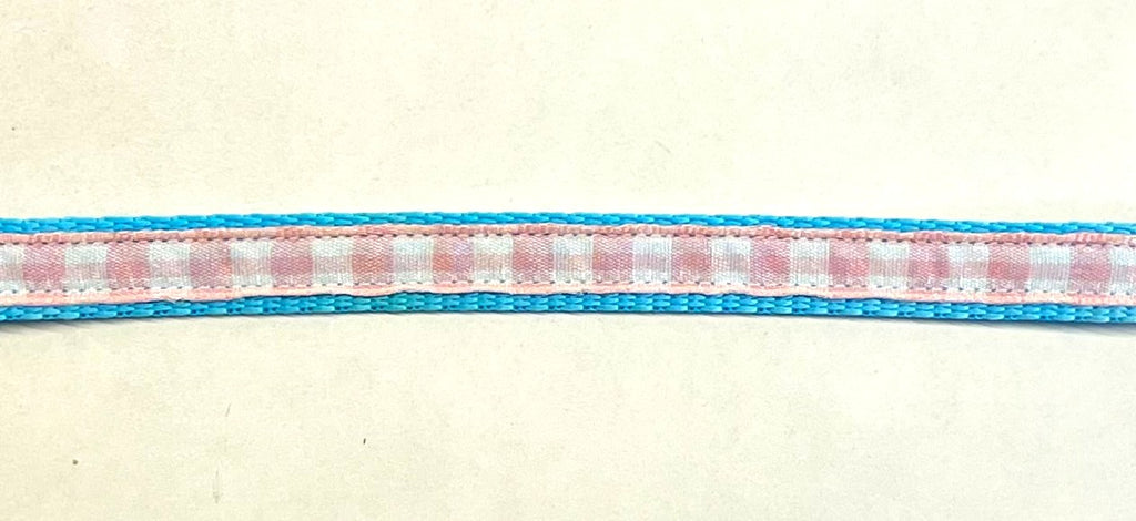 Light pink and white plaid ribbon on turquoise webbing dog collar