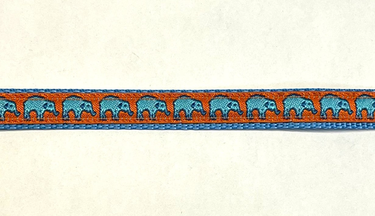 Orange ribbon with turquoise elephants on light blue webbing dog collar