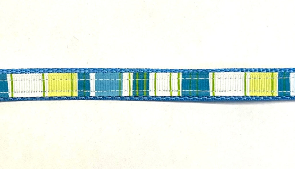 Blue ribbon with white, light green, green, and turquoise vertical stripes on light blue webbing dog collar