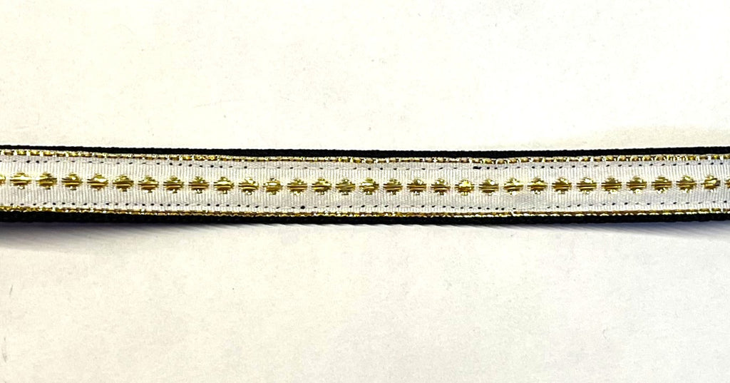 White ribbon with gold dots and stripe on black webbing dog collar