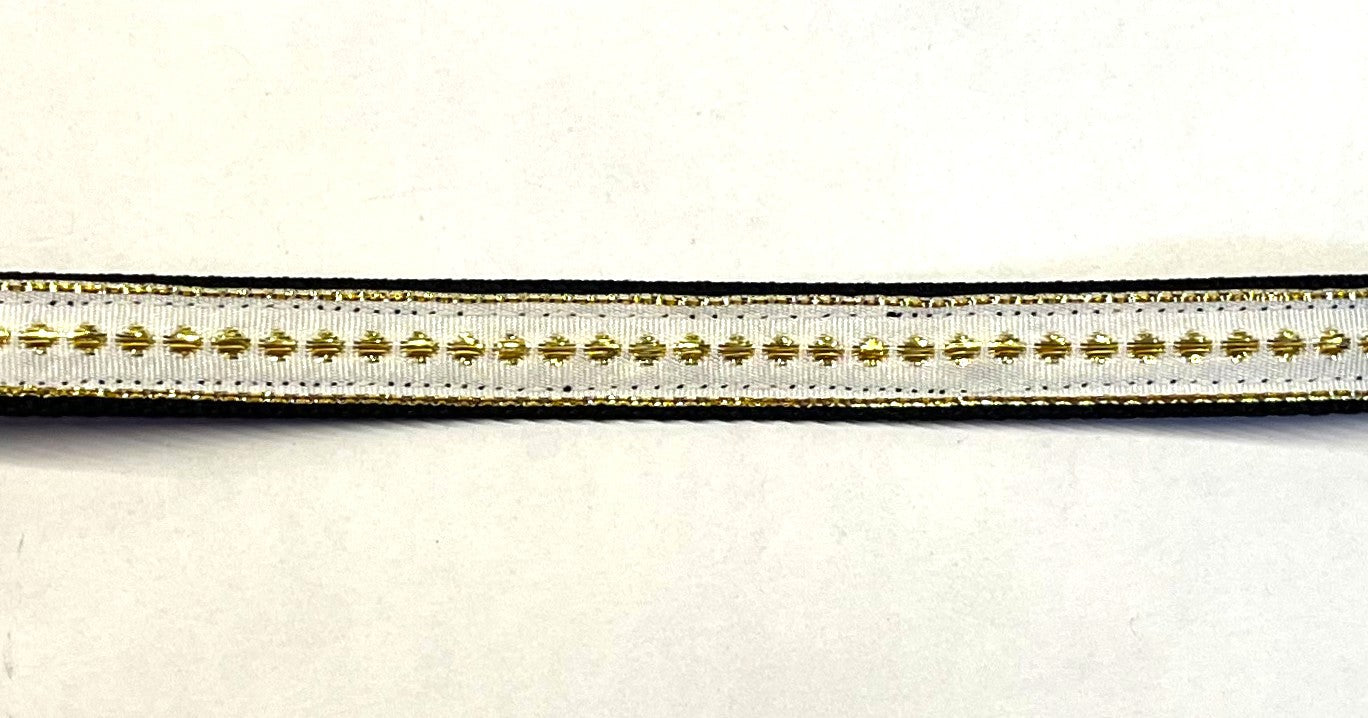 White ribbon with gold dots and stripe on black webbing dog collar