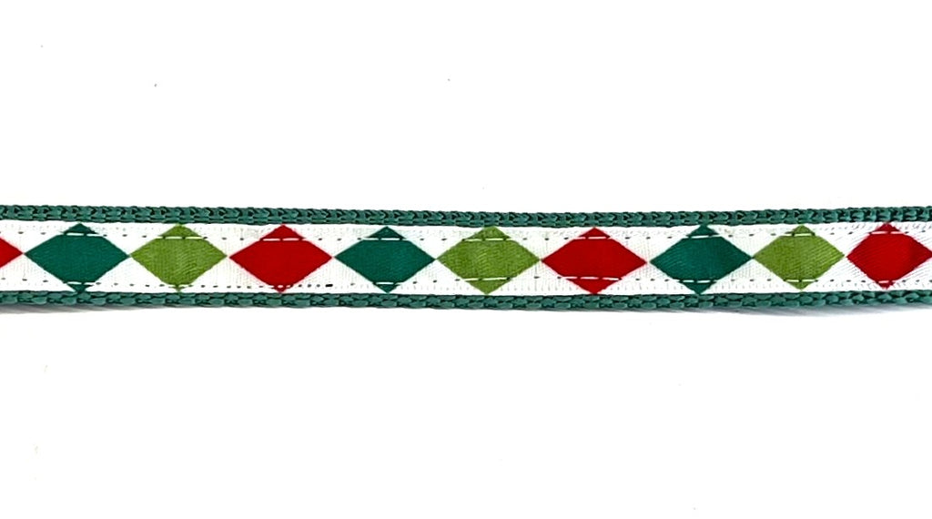 White ribbon with dark green, lime green, and red diamond pattern dog collar on green webbing