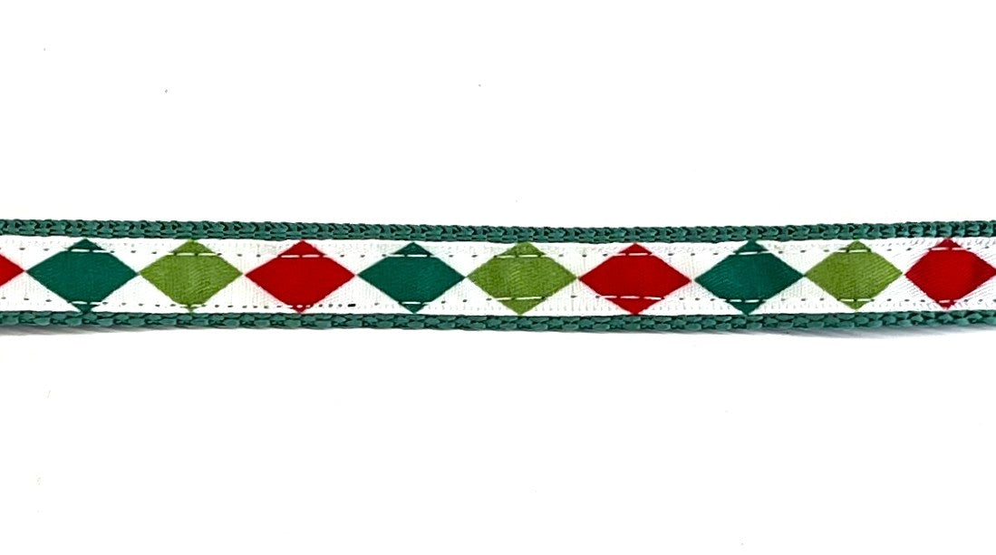 White ribbon with dark green, lime green, and red diamond pattern dog collar on green webbing