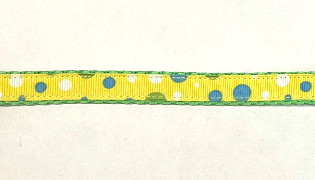 Yellow ribbon with blue and white bubble dots dog collar on green webbing