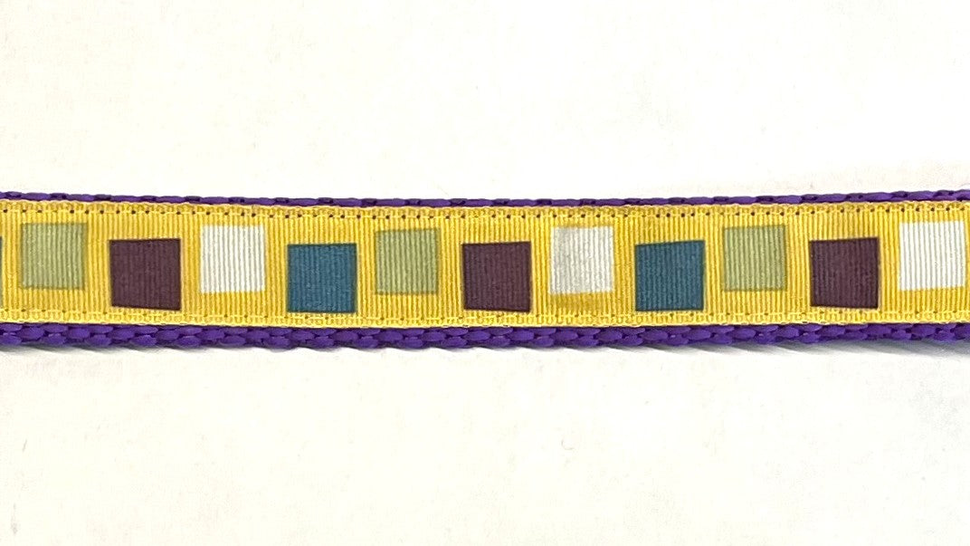 Yellow with teal, purple, olive, and white squares dog collar on purple webbing